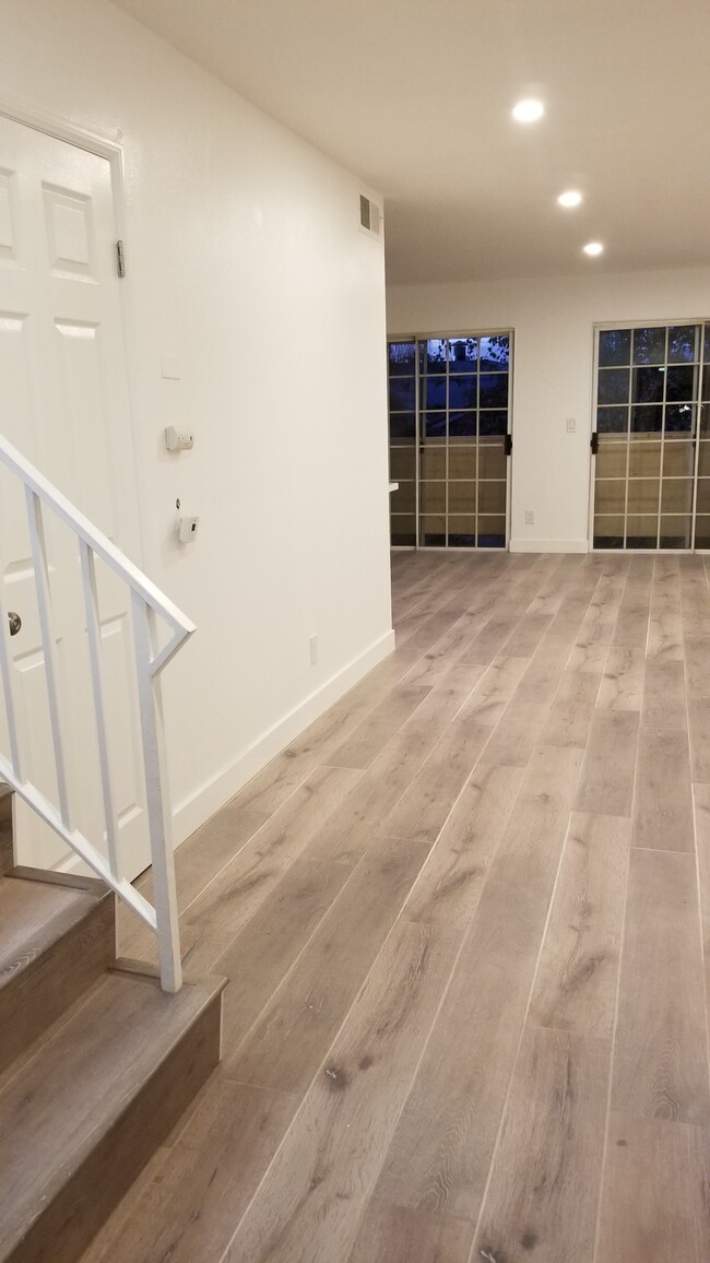 Downstairs Landing, Double Sliding Balcony Doors, Front Door view - 14126 Tiara St