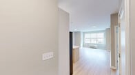This thoughtfully designed two-bedroom, two-bathroom residence at 968 Bonnel Court, Unit 301 in Union, NJ offers a clean, modern aesthetic throughout its well-proportioned floor plan. Light wood flooring flows seamlessly across the entire unit, lending warmth and continuity to every room.

The open-concept kitchen and living area serves as the heart of the home. The kitchen is appointed with stainless steel appliances, including a gas range, microwave, and French door refrigerator, complemented by white upper cabinetry, two-tone lower cabinetry, and a subway tile backsplash. A large island with a quartz countertop and undermount sink provides additional prep space and casual seating. Pendant lighting above the island adds a contemporary touch. The adjacent living area benefits from large windows that invite abundant natural light.

Both bedrooms are generously sized with neutral-toned walls and windows overlooking the surrounding neighborhood. The primary bedroom is notably spacious and well-lit. The two bathrooms offer distinct finishes — one features elegant marble-style tile flooring and a glass-enclosed shower, while the second includes a soaking tub with a terrazzo-style surround. A dedicated closet provides practical storage. The unit's clean lines, modern finishes, and bright, airy atmosphere create a comfortable and contemporary living environment.