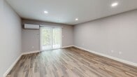 Located at 35 Madelyn Way in Laconia, NH, this thoughtfully designed multi-level home spans three floors and offers 2 bedrooms and 2 bathrooms. The main level serves as the heart of the home, centered around a stylish kitchen outfitted with gray shaker cabinetry, quartz countertops, a white subway tile backsplash, stainless steel appliances including a French door refrigerator and range, and warm hardwood flooring. Recessed lighting and a window overlooking the outdoors add brightness to the space. The adjacent living area extends the main floor's open feel. Upstairs, two carpeted bedrooms provide comfortable retreats, each featuring ceiling fans and generous closet space, including a double sliding-door closet in the primary bedroom. The two bathrooms are finished with gray vanities, quartz countertops, and matte black hardware accents, with one bathroom featuring a tub-shower combination. The lower level offers a spacious living area with durable wood-look flooring, recessed lighting, sliding glass doors that bring in natural light and outdoor views, and a dedicated laundry room with full-size washer and dryer. A mini-split system on this level ensures year-round comfort. Three staircases connect the floors, creating smooth circulation throughout this well-finished Laconia home.