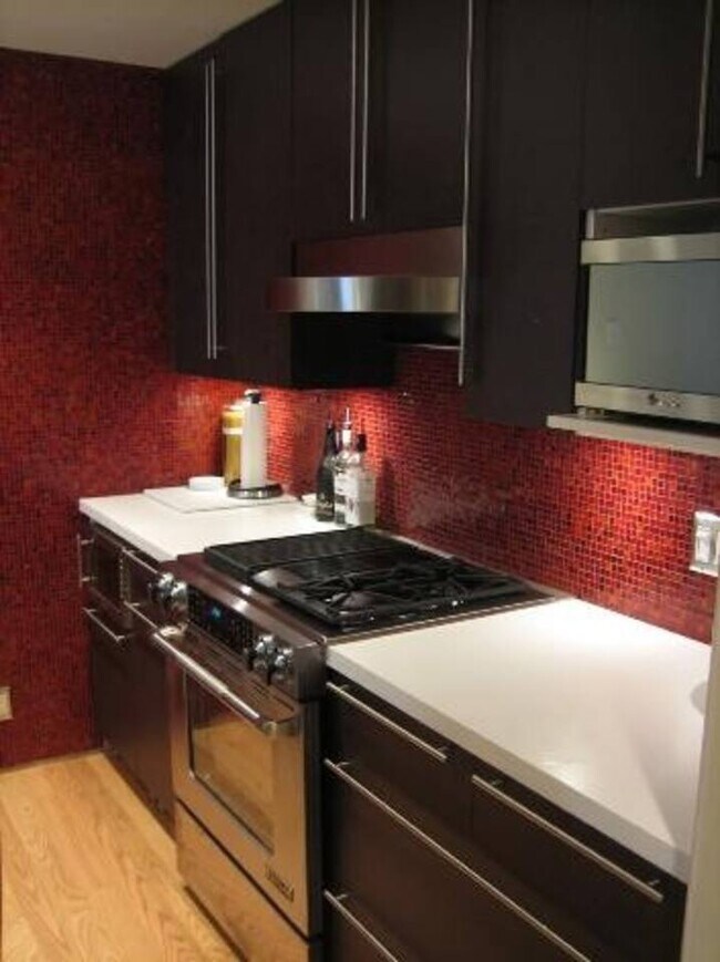 Modern, renovated kitchen featuring refrigerator, dishwasher, microwave, wine fridge, garbage disposal - 469 Clementina Street