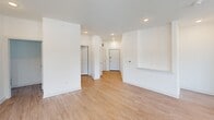 Located at 10 Calm Water Drive in Asheville, NC, this well-appointed two-bedroom, one-bathroom residence offers a thoughtfully designed single-level floor plan with a clean, modern aesthetic throughout. Light wood-style flooring flows seamlessly across all areas, complementing the bright white walls and trim that give the space an open, airy feel.

The combined kitchen and living area serves as the heart of the home. The kitchen is outfitted with white shaker-style cabinetry, a classic subway tile backsplash, granite countertops, and a full suite of stainless steel appliances including a refrigerator, range, microwave, and dishwasher. A central island with an undermount sink and pendant lighting above adds both functionality and style. Multiple windows flood the space with natural light and offer pleasant outdoor views.

Both bedrooms are well-sized, each featuring ceiling fans, large windows with blinds, and light-filled interiors. The primary bedroom benefits from a generous walk-in closet outfitted with wire shelving systems for organized storage.

The full bathroom features a dual-sink vanity with granite countertops, white cabinetry, brushed nickel hardware, and updated fixtures, delivering a polished and functional design. A dedicated laundry area with utility hookups rounds out this comfortable and move-in ready Asheville residence.