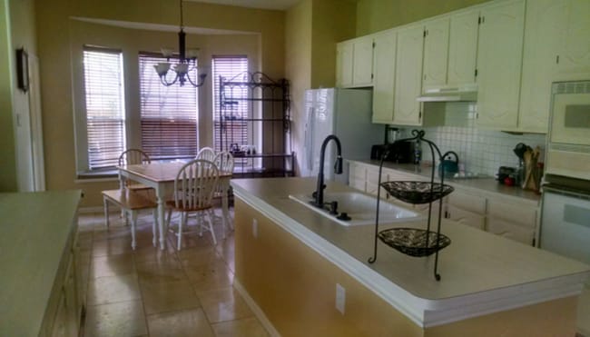 A beautifully appointed open-air kitchen with a built-in gas stove, abundant custom-style cabinetry - 10913 Alexandria Dr