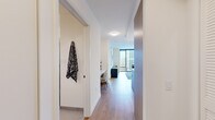 Located at 350 N Canal Street in Chicago's vibrant Fulton River District, this well-appointed one-bedroom, two-bathroom residence offers a thoughtfully designed layout with contemporary finishes throughout. Wide-plank hardwood flooring flows seamlessly across the space, anchoring a clean, modern aesthetic.

The open-concept living area is defined by dramatic floor-to-ceiling windows that frame sweeping views of the Chicago skyline, flooding the room with natural light. The kitchen features sleek white cabinetry with wood accents, a tiled backsplash, stainless steel appliances including a refrigerator, microwave, and range, and a generous island with a quartz countertop and bar seating — ideal for both everyday meals and entertaining.

The bedroom is a serene retreat, also benefiting from expansive windows with city views. Its bright, neutral palette and ample proportions create a calm and restful atmosphere.

Both bathrooms are finished with large-format tile floors, clean white fixtures, and warm wood vanities. The full bath includes a soaking tub and shower combination, while the second bath provides added convenience for guests.

A well-proportioned entry hallway connects all areas with ease, completing this efficiently planned and stylish urban residence.