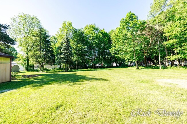 Open flat lawn stretches to the back fence of the property - 608 Schultz St