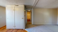 Located at 1724 Heritage Cir in Fort Collins, Colorado, this single-floor residence offers a straightforward and functional layout throughout. The interior features a mix of hardwood flooring in key areas and wall-to-wall carpet in the bedrooms and living spaces, providing a comfortable and cohesive feel underfoot. Textured popcorn ceilings are consistent throughout the home, adding a classic residential character. The bedrooms are well-proportioned, with one featuring a ceiling fan and a window that looks out to mature surrounding trees, allowing for natural light and a connection to the outdoors. Closet space is present in the bedroom areas, with full-height doors offering ample storage. A central hallway connects the rooms, with overhead lighting guiding the way. The bathroom is equipped with a wall-mounted sink, a medicine cabinet with mirror, and a full bathtub with shower fixtures, providing all essential amenities. Neutral warm-toned walls throughout the home create a clean and versatile backdrop. The overall layout, as seen in the dollhouse view, is compact and efficiently organized, making practical use of the available single-floor footprint.