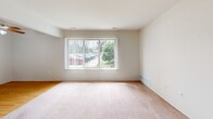 Located at 4575 Turner St in Trenton, Michigan, this two-bedroom, one-bathroom residence offers a practical and functional single-floor layout. The floor plan, as seen in the dollhouse view, reveals a logical flow between living spaces, hallways, a kitchen, and bedrooms. The spacious primary bedroom features soft carpeting, neutral walls, and a large window with vertical blinds that allows ample natural light and views of the surrounding greenery. The second bedroom is similarly finished with carpet flooring, a natural-light window, and a closet, making it well-suited as a guest room or home office. Both bedrooms are connected via carpeted hallways that provide easy circulation throughout the unit. The kitchen is equipped with wood-toned cabinetry, a stove, refrigerator, and hardwood-style flooring, offering a warm and utilitarian cooking space. The bathroom is cleanly appointed with tile flooring, a full soaking tub and shower combo, a granite-topped vanity, and a window that invites natural light and ventilation. Throughout the home, neutral tones and consistent finishes create a cohesive and move-in-ready atmosphere suited for a variety of residents.