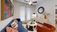 This thoughtfully designed 2-bedroom, 2-bathroom residence in Anna, TX offers a bright, open-concept layout with modern finishes throughout. Light wood-style flooring flows seamlessly across the entire space, complementing the clean white walls and creating a cohesive, contemporary aesthetic.

The kitchen is a standout feature, showcasing granite countertops, a large island with bar seating, gray shaker-style cabinetry, stainless steel appliances, and elegant pendant lighting. It opens directly to the dining and living areas, making the layout ideal for everyday living and entertaining. The living room is well-lit with natural light pouring in through French doors and features a ceiling fan overhead.

The primary bedroom offers a comfortable retreat with large windows, a ceiling fan, and access to a private en-suite bathroom. The en-suite features granite countertops, dark wood cabinetry, a walk-in closet, and a soaking tub. The second bedroom is equally well-sized, also appointed with a ceiling fan and natural light. The second bathroom mirrors the same quality finishes. Both bedrooms include dedicated closets with built-in shelving and hanging rods for ample storage.