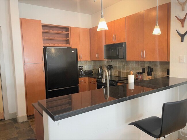 Everything you need in a kitchen! Refrigerator, plates, glasses, silverware, small appliances. - 1901 Post Oak Blvd