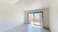 Located at 4945 Mack Rd in Sacramento, CA, this thoughtfully designed 2-bedroom, 1-bathroom residence offers a clean, modern aesthetic throughout its single-floor layout. Light wood-style flooring runs consistently across all rooms, lending a cohesive and contemporary feel to the entire space.

The combined kitchen and living area serves as the heart of the home. The kitchen is outfitted with gray shaker-style cabinetry, granite-look countertops, stainless steel appliances including a full-size refrigerator, and a built-in range — all complemented by ample upper and lower cabinet storage. The living room features vaulted ceilings and a sliding glass door that opens onto a private balcony, filling the space with abundant natural light and providing outdoor access with neighborhood views.

The spacious primary bedroom includes a sliding glass door to the balcony, vaulted ceilings, and generous proportions. The second bedroom offers a large window with exterior views and a built-in sliding closet. Both rooms are bright and airy with clean white walls.

The bathroom is well-equipped with a granite-top vanity, a full tub and shower combination with tiled surround, and modern fixtures. A connecting hallway ties all rooms together efficiently, completing this functional and attractive Sacramento residence.