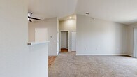 Located at 105 Landmark Dr in Council Bluffs, Iowa, this one-bedroom, one-bathroom unit offers a thoughtfully designed single-floor layout with a clean, modern aesthetic. The open-concept living area features vaulted ceilings that enhance the sense of space, soft carpeting underfoot, and a sliding glass door that opens to a private balcony, filling the room with natural light. A ceiling fan adds both comfort and style to the living space. The kitchen is well-equipped with white shaker-style cabinetry, white countertops, and a full suite of stainless steel appliances including a refrigerator, electric range, microwave, and dishwasher. Wood-look flooring and pendant lighting complete the kitchen's contemporary feel. The bedroom is a comfortable retreat with plush carpet, a ceiling fan, a large window with vertical blinds, and access to a dedicated walk-in closet outfitted with wire shelving for organized storage. The bathroom features wood-look flooring, a single-sink vanity with storage, a lighted mirror, a tub-shower combination, and black accent hardware throughout. Neutral tones and clean finishes lend the entire unit a cohesive, move-in-ready appearance.