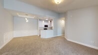 Located at 800 Gunn Rd in Centerville, Georgia, this single-floor home offers a thoughtfully designed open-concept layout finished in a clean, neutral palette throughout. The living and dining areas flow seamlessly together, highlighted by plush wall-to-wall carpeting, decorative wainscoting, and stylish pendant lighting. A tray ceiling detail in the dining area adds a refined architectural touch.

The kitchen is well-appointed with white shaker-style cabinetry, granite countertops, stainless steel appliances including a range, microwave, refrigerator, and dishwasher, along with light wood-look flooring. A peninsula with a breakfast bar connects the kitchen to the main living space, making it ideal for entertaining.

The bedrooms are generously sized with plush carpeting, ceiling fans, and windows that bring in natural light. Vaulted ceilings in the primary bedroom enhance the sense of openness, while a dedicated hallway leads to connected bathroom access.

Both bathrooms feature white cabinetry, granite countertops, undermount sinks, matte black fixtures, and wood-look tile flooring. The primary bath includes a double vanity and a soaking tub-shower combination. A second full bath mirrors the same quality finishes. Carpeted hallways connect the private areas of the home, completing a cohesive and well-maintained interior.