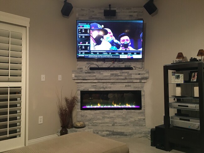 Main living entertainment center w/modern fireplace. - 8720 Red Rio Dr