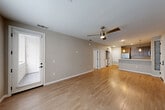 Located at 1113 Baywood Dr in Petaluma, California, this single-floor, one-bedroom, one-bathroom residence offers a thoughtfully designed layout with a clean, modern aesthetic throughout. Light wood-tone flooring runs across the main living areas, complemented by neutral gray walls and white trim that create a bright, cohesive look.

The open-concept living, dining, and kitchen area serves as the heart of the home. The kitchen is well-appointed with warm wood-grain cabinetry extending to the ceiling, stainless steel appliances including a gas range, microwave, and refrigerator, white quartz countertops, and a peninsula with pendant lighting that doubles as a breakfast bar. The living area features a ceiling fan and receives natural light through large windows and a glass exterior door.

A separate den provides flexible additional space, while two closets offer ample storage. The bedroom is carpeted for comfort and includes a window with natural light. The bathroom is finished with wood-grain cabinetry, a white countertop vanity, a framed mirror, and wood-look flooring. In-unit stacked laundry and a dedicated utility room add practical convenience. The overall design is modern and move-in ready.