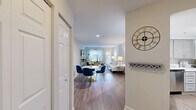 Located at 3113 Pine Orchard Ln in Ellicott City, MD, this 2-bedroom, 2-bathroom single-floor home offers a thoughtfully designed layout with modern finishes throughout. The open-concept living and dining area is anchored by warm hardwood-style flooring, neutral walls, and natural light from front-facing windows, creating a bright and welcoming atmosphere. The space flows seamlessly from a defined dining area into the living room, making it well-suited for both everyday living and entertaining.

The kitchen features gray shaker-style cabinetry, white quartz countertops, and stainless steel appliances including a dishwasher and range, all tied together with the same hardwood-style flooring that runs through the main living area.

The generously sized primary bedroom offers plush carpeting and ample room for a large bed and furnishings. The second bedroom, also carpeted, includes a bright window that fills the space with natural light. Both bathrooms are finished with gray vanity cabinetry, white countertops, wood-look flooring, and shower-tub combinations with updated fixtures and well-lit vanity mirrors.

A connecting hallway ties the rooms together efficiently, and the overall design palette of soft grays, whites, and warm wood tones lends a clean, contemporary feel throughout the home.