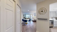 Located at 3113 Pine Orchard Ln in Ellicott City, MD, this 2-bedroom, 2-bathroom single-floor home offers a thoughtfully designed layout with modern finishes throughout. The open-concept living and dining area is anchored by warm hardwood-style flooring, neutral walls, and natural light from front-facing windows, creating a bright and welcoming atmosphere. The space flows seamlessly from a defined dining area into the living room, making it well-suited for both everyday living and entertaining.

The kitchen features gray shaker-style cabinetry, white quartz countertops, and stainless steel appliances including a dishwasher and range, all tied together with the same hardwood-style flooring that runs through the main living area.

The generously sized primary bedroom offers plush carpeting and ample room for a large bed and furnishings. The second bedroom, also carpeted, includes a bright window that fills the space with natural light. Both bathrooms are finished with gray vanity cabinetry, white countertops, wood-look flooring, and shower-tub combinations with updated fixtures and well-lit vanity mirrors.

A connecting hallway ties the rooms together efficiently, and the overall design palette of soft grays, whites, and warm wood tones lends a clean, contemporary feel throughout the home.