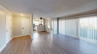 This single-story, 3-bedroom, 2-bathroom home features a thoughtfully designed layout that balances comfort and functionality. The open living and dining area is finished with durable wood-look plank flooring, crown molding, and a ceiling fan, with a large sliding glass door fitted with vertical blinds that fills the space with natural light. A built-in wall unit provides convenient climate control directly in the living area.

The kitchen is a standout feature, showcasing white shaker-style cabinetry, dark granite-look countertops, a bold navy blue backsplash, and stainless steel appliances including a range, microwave, and dishwasher. A built-in wine rack adds a stylish touch, and the kitchen opens conveniently to the main living area.

The bedrooms are carpeted and accented with crown molding and textured ceilings. Each room offers natural light through blinds-fitted windows, with the primary suite providing direct access to an en-suite bathroom. The bathrooms feature white vanity cabinetry, warm countertops, mirrored medicine cabinets, and shower/tub combinations. The second bathroom includes a separate water closet for added privacy. Throughout the home, consistent white trim and neutral tones create a clean, cohesive aesthetic.