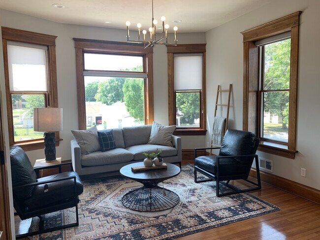 Gorgeous living room featuring the original 1907 wood flooring and trim. - 218 Central Ave NE