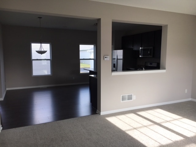 Living room view, looking into kitchen. - 2571 W 127th Pl