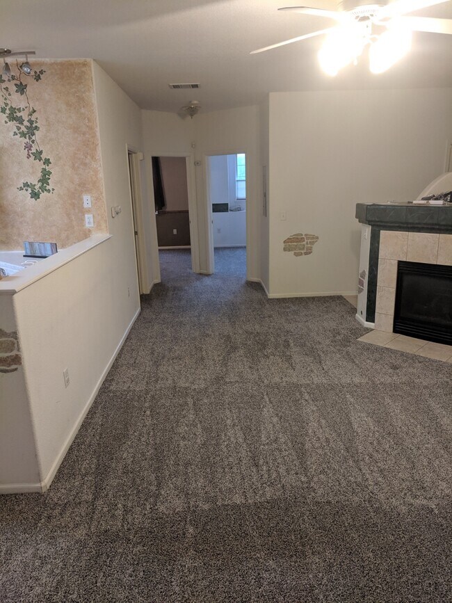 Main living room and fireplace. New Carpet! - 3282 E 103rd Dr