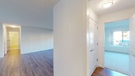 Located at 2 Harness Court in Pikesville, Maryland, this single-floor, two-bedroom residence offers a thoughtfully designed layout with a clean, neutral aesthetic throughout. The open living and dining area is a standout feature, with wide-plank hardwood-style flooring, a ceiling fan, and a large sliding window that brings in natural light and outdoor views. A hallway connects the main living space to the private quarters, maintaining an organized and functional flow.

The galley-style kitchen is well-equipped, showcasing rich dark cabinetry, granite countertops, a subway tile backsplash, and a full suite of stainless steel appliances including a refrigerator, dishwasher, microwave, and electric range, all set above light hardwood flooring.

Both bedrooms are generously sized and feature plush carpeting, wide windows for natural light, and ample closet storage provided by multiple built-in sliding closets with hanging rods. The bathrooms are finished with wood-toned vanities, granite or solid-surface countertops, large mirrors, and hardwood-style flooring, maintaining a consistent, polished look throughout the residence.