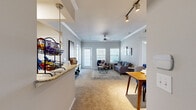 This single-floor, 2-bedroom, 2-bathroom residence is thoughtfully designed to maximize comfort and functionality. The open-plan living and dining area serves as the heart of the home, featuring plush carpet flooring, crown molding, and a ceiling fan. Large windows along the exterior wall flood the space with natural light and offer outdoor views, while a track lighting system and pendant fixtures provide additional illumination. The living area connects seamlessly to a dedicated dining space.

The kitchen features light wood cabinetry, granite-style countertops, tile flooring, and a peninsula that opens toward the dining area — ideal for both cooking and entertaining. A pantry and in-unit laundry area add to the home's practicality.

The primary bedroom is generously sized, highlighted by an arched window that brings in ample natural light, carpet flooring, and a ceiling fan. It is complemented by a private en-suite bathroom with a walk-in shower, tile flooring, and a spacious walk-in closet fitted with wire shelving systems. The second bedroom is equally well-appointed with its own ceiling fan and comfortable proportions. A second full bathroom with a glass-enclosed shower serves this bedroom and guests. Three closets throughout the home ensure abundant storage.