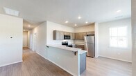 Located at 1666 W Cumberland Rd in Tyler, TX, this single-story, three-bedroom, one-bathroom home offers a well-designed layout with a clean, modern aesthetic. The open-concept kitchen and living area serves as the heart of the home, featuring a peninsula with granite countertops and seating, taupe shaker-style cabinetry extending to the ceiling, and a full suite of stainless steel appliances including a refrigerator, electric range, and over-the-range microwave. Light wood-style flooring runs throughout the main living areas, lending a bright and cohesive feel to the space.

The three bedrooms are thoughtfully sized, with the generously proportioned primary bedroom offering plush carpeting, a ceiling fan, and a walk-in closet. The additional bedrooms also feature carpet and windows that invite natural light and outdoor views of the surrounding landscape. The full bathroom is finished with a dark-cabinetry vanity topped with a granite-style countertop, a tub-shower combo, and matching light wood flooring. Throughout the home, neutral wall tones, recessed lighting, and clean white trim create a fresh, move-in-ready atmosphere well-suited for comfortable everyday living.