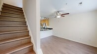 Located at 9712 Tartuffe Drive in Henrico, VA, this 580-square-foot, two-story residence offers 1 bedroom and 2 bathrooms across a thoughtfully arranged layout. The main floor spans 380 square feet and centers around an open-concept kitchen and living area. The kitchen is outfitted with warm maple cabinetry, dark granite countertops, stainless steel appliances including a gas range, microwave, dishwasher, and refrigerator, complemented by track lighting overhead. A curved peninsula provides a natural divide between the kitchen and living space. French doors at the rear of the living area invite natural light throughout. A convenient in-unit stacked washer and dryer is tucked neatly into the kitchen area. A half bathroom on the main floor features a pedestal sink, hardwood-style flooring, and brushed nickel fixtures. The upper floor covers 200 square feet and contains the primary bedroom, measuring 130 square feet, with plush carpeting, a large window offering exterior views, and access to two closets. The full bathroom on this level features a tiled tub-shower combination. A staircase and hallway connect both levels, completing this compact yet efficiently designed home.