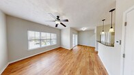 Located at 5005 Iris Ave in Fort Wayne, Indiana, this single-floor, one-bedroom, one-bathroom unit offers a well-organized layout designed for comfortable everyday living. The open-concept living and dining area is a highlight, featuring warm hardwood-style flooring, a ceiling fan with light fixture, and large windows that fill the space with natural light and provide neighborhood views. A sliding glass door offers additional access and light to the living area.

The kitchen is thoughtfully designed with white cabinetry, dark granite-style countertops, a tile backsplash, and black appliances including a refrigerator, range, and microwave. A peninsula with pendant lighting bridges the kitchen and living area, ideal for casual dining or entertaining.

The bedroom is carpeted for comfort and includes a walk-in closet with built-in shelving, as well as an additional closet, offering generous storage. A window brings in natural light and a neighborhood view.

The bathroom features a full tub-shower combination with tiled surround and hardwood-style flooring. The unit also includes a dedicated laundry area and utility room, adding practical convenience. A hallway connects the private spaces, completing this efficient and well-appointed home.