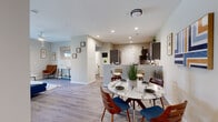 Located at 100 Grenache Blanc Dr in Saint Peters, Missouri, this single-floor residence offers a thoughtfully designed open-concept layout that seamlessly connects the living, dining, and kitchen areas. Light wood-look flooring runs throughout the main living spaces, complemented by neutral-toned walls and recessed lighting that create a bright, welcoming atmosphere.

The kitchen is equipped with dark cabinetry, granite countertops, stainless steel appliances, and a peninsula with bar seating — ideal for casual dining or entertaining. The adjacent dining area provides dedicated space for a full dining table. The living room features a ceiling fan, sliding glass doors, and direct access to a private balcony with outdoor views.

The bedrooms are carpeted for added comfort, each outfitted with ceiling fans and ample closet space, including mirrored sliding closet doors in one room. Natural light flows in through large windows with window treatments. The bathroom features a granite vanity, dark cabinetry, and light flooring, maintaining the consistent, modern aesthetic found throughout the residence.

The overall design balances contemporary finishes with functional living spaces, making this Saint Peters property a well-appointed and comfortable home.