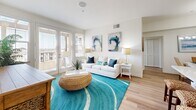 Located in San Diego, CA, this well-appointed 2-bedroom, 3-bathroom unit offers a thoughtfully designed single-level layout with a coastal aesthetic throughout. The open-concept living area is bathed in natural light from large sliding glass doors that lead to a balcony, creating a seamless indoor-outdoor connection. Light wood-style flooring runs through the main living spaces, complementing the bright, neutral palette.

The kitchen features rich dark-espresso cabinetry, stainless steel appliances including a gas range and refrigerator, a white quartz countertop, subway tile backsplash, and a convenient island with a sink. Adjacent to the kitchen, the dining area offers an elegant tray ceiling and chandelier overhead. A dedicated closet provides additional storage off the dining space.

Both bedrooms are carpeted and filled with natural light from well-placed windows. The spacious primary bedroom includes a walk-in closet and an en-suite bathroom, while the second bedroom is comfortably sized and shares access to additional bathrooms. The bathrooms are finished with dark vanity cabinetry and a sleek glass-enclosed tile shower with marble-style surround and mosaic accent border.

The overall ambiance is light, airy, and coastal — a comfortable and stylish home in the heart of San Diego.