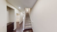Located at 10500 Sea Pearl Cove in San Diego, CA, this well-appointed three-story home offers five bedrooms and four bathrooms across generously distributed living space. The layout is thoughtfully spread over three floors, each connected by carpeted staircases with clean white railings and warm neutral-toned walls throughout.

The main level features an open-concept kitchen and living area, anchored by rich dark wood cabinetry, granite countertops, a peninsula island, and stainless steel appliances. Dark hardwood flooring runs through the main living areas, complemented by natural light from multiple windows with blinds.

The bathrooms range from a compact pedestal-sink powder room with an oval mirror to a full primary bathroom featuring a double-sink vanity with dark wood cabinets, white quartz countertops, a glass-enclosed shower, and hardwood floors. The bedrooms are carpeted and bright, with several featuring windows that bring in natural light and closets with sliding panel doors.

Hallways connect the floors efficiently, and a dedicated closet adds storage convenience. The primary bedroom provides a comfortable private retreat. With a neutral color palette, recessed lighting, and consistent modern finishes, this multi-story home offers a clean, functional, and versatile living environment ideal for larger households.