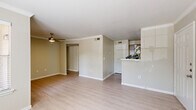 Located at 333 Normandy St in Houston, TX, this single-floor, three-bedroom, two-bathroom home offers a functional and well-organized layout. The living room features light hardwood-style flooring, crown molding, and multiple windows fitted with blinds that allow generous natural light while maintaining privacy. A ceiling fan adds comfort to the open feel of the space. The galley-style kitchen is thoughtfully appointed with grey cabinetry, white countertops, stainless steel appliances including a refrigerator, electric range, and built-in microwave, complemented by a double sink and light vinyl flooring. The three bedrooms are carpeted and each include a ceiling fan with light fixture. The spacious primary bedroom features a walk-in closet and a window overlooking the outdoors. The secondary bedrooms are well-proportioned with individual windows and panel-style doors. A carpeted hallway connects the bedrooms and two full bathrooms. One bathroom offers a vanity with grey cabinetry and a tub-shower combination, while the second features a similarly styled vanity with light vinyl flooring. Neutral warm-beige tones throughout the home create a cohesive and welcoming ambiance.