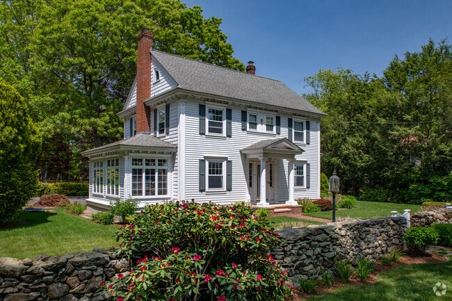 Mature gardens add life and color to homes in East Greenwich.