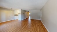 Located at 1985 Pleasant Valley Ave in Oakland's Pleasant Valley neighborhood, this single-story, 2-bedroom, 1-bathroom home offers a clean and functional layout throughout. Light hardwood flooring runs continuously across all rooms, lending warmth and visual cohesion to the entire space.

The combined living and dining area is the heart of the home, featuring multiple sliding windows that invite generous natural light and offer views of the surrounding greenery. A pendant light fixture anchors the dining zone, while the open flow into the kitchen makes the area well-suited for everyday living and entertaining.

The kitchen is outfitted with white cabinetry, a full-size refrigerator, and ample counter space, with a pantry providing additional storage. A utility room adds further practicality to the layout.

Both bedrooms are comfortably sized, each with hardwood floors and windows that bring in natural light. The primary bedroom includes a large sliding-door closet, while the second bedroom also features a built-in closet. A hallway connects the bedrooms to the rest of the home, with a total of three closets spread throughout.

The single bathroom and well-organized hallway complete this efficient, move-in-ready home with a bright, neutral palette throughout.