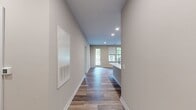Located at 751 Vandenburg Rd, Apt 3106 in King of Prussia, PA, this 1,050-square-foot apartment features 2 bedrooms, 2 bathrooms, and a thoughtfully designed single-floor layout. The kitchen is a standout, showcasing rich walnut-toned shaker cabinetry, white quartz countertops, a classic subway tile backsplash, stainless steel appliances, and a central island with a built-in sink — ideal for both cooking and entertaining. Hardwood-style flooring flows consistently throughout the unit, complementing the neutral, warm-toned walls. The open living area features recessed lighting and a glass-paneled door leading to a private balcony, filling the space with natural light. Both bedrooms are well-sized, each equipped with ceiling fans, large windows with outdoor views, and dedicated closets. The primary bedroom spans 200 square feet and includes a walk-in closet with wire shelving. The en-suite primary bathroom offers a glass-enclosed walk-in shower, a wood-cabinet vanity with a white countertop, and tile flooring. The second bathroom mirrors the same quality finishes with a full soaking tub and shower combination. Two closets provide ample storage throughout the unit.