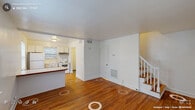 Located at 803 Demerius St in Durham, NC, this two-story home offers a thoughtfully organized layout spread across two floors. The main level features a combined kitchen and living room area anchored by rich hardwood flooring that flows throughout the space. The kitchen is equipped with white cabinetry, a full-size refrigerator, an electric range with overhead ventilation, and ample counter space, all brightened by natural light from multiple windows. The open living area connects seamlessly to the kitchen, with a staircase leading to the upper floor.

Upstairs, two bedrooms provide comfortable personal retreats, each featuring the same warm hardwood flooring, neutral wall tones, and windows that bring in natural light and outdoor views. The primary bedroom is generously sized and includes closet storage, while the second bedroom also benefits from bright, multi-window exposure. The full bathroom is finished with classic white tile, a tub/shower combination, a pedestal sink, and a window for natural ventilation.

A dedicated laundry room with a full-size washer and dryer, granite-style countertop, and abundant white cabinetry adds everyday convenience. The home's clean, bright aesthetic and consistent hardwood flooring create a cohesive and welcoming atmosphere throughout.