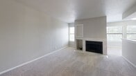 Located at 1703 S Jackson Ave in Tulsa, Oklahoma, this single-story 2-bedroom, 3-bathroom home offers a practical and comfortable layout throughout. The living room serves as a welcoming centerpiece, featuring a tile-surround fireplace with built-in shelving above, a window that brings in natural light, and wall-to-wall carpeting that adds warmth to the space. The kitchen is designed for efficiency, featuring white cabinetry, light stone-look countertops, wood-look flooring, and black appliances including a range, microwave, and refrigerator. It opens conveniently toward the rest of the home. Both bedrooms are carpeted and equipped with ceiling fans, providing comfortable retreats. The primary bedroom includes direct access to its own bathroom and a dedicated closet, while a second closet offers additional storage. The bathrooms are clean and functional — one features a tub-shower combo with white tile surround, another includes a walk-in shower, and a third provides a vanity with stone-look countertops. Throughout the home, neutral gray tones, white trim, and wood-look flooring in wet areas create a cohesive, understated aesthetic well-suited for everyday living.