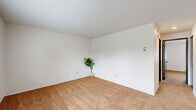 Located on Cherrywood Avenue in Bellingham, Washington, this one-bedroom, one-bathroom unit offers a practical and well-organized single-floor layout. The living room is carpeted and bright, featuring a large window with blinds that frames views of the surrounding neighborhood greenery, along with baseboard heating and a textured ceiling throughout.

A notable feature of this unit is its dual kitchen configuration. The primary kitchen is a galley-style space equipped with dark espresso cabinetry, a white electric range, refrigerator, dishwasher, double sink, and tile flooring — providing ample storage and functional counter space. A secondary kitchen area offers additional cabinetry, a sink, dishwasher, and a dining nook — an uncommon and versatile arrangement.

The bedroom is carpeted with a window allowing natural light, a closet with a dark wood panel door, and baseboard heating. The bathroom features tile flooring, a vanity with dark wood cabinetry, a mirrored medicine cabinet, and clean white fixtures. A hallway connects the rooms efficiently, keeping the layout cohesive. Dark wood doors are consistent throughout the unit, adding a warm contrast to the white walls and neutral carpet tones.