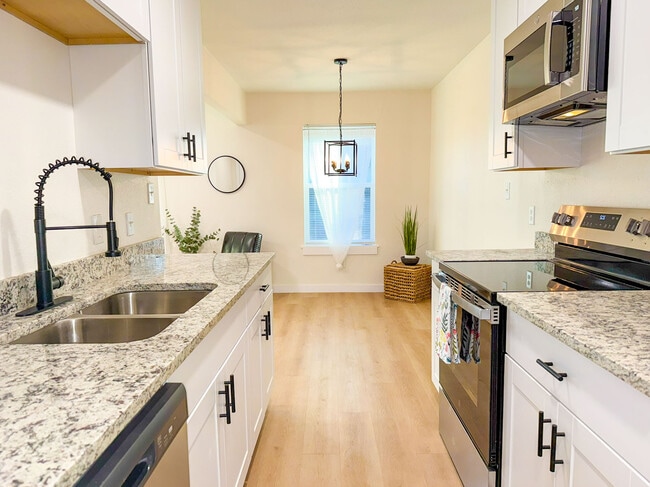 Kitchen with stainless appliances. - 308 E Bourn St