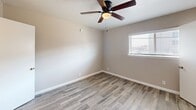 Located at 212 S Cooper St in Arlington, TX, this well-appointed one-bedroom, one-bathroom unit offers a smart and functional layout across a single floor. Wood-look plank flooring runs consistently throughout the space, lending a clean and cohesive aesthetic to every room.

The combined dining and kitchen area features white cabinetry with ample upper and lower storage, a subway tile backsplash, a full-size refrigerator, and a deep sink — all finished in a bright, neutral palette that maximizes the sense of openness. Adjacent to the kitchen, a built-in cabinet and shelving unit provides additional display and storage versatility.

The living room connects naturally to the rest of the layout, offering a comfortable and open gathering space. The bedroom is a well-sized retreat, complete with a ceiling fan, a window that brings in natural light, and easy access to multiple closets — three in total throughout the unit — ensuring generous storage throughout.

The bathroom is finished with wood-look flooring, white wainscoting, a tiled tub/shower combo, and a marble-look countertop vanity, creating a clean and refined look. Neutral warm-gray walls and consistent white trim tie the entire unit together, resulting in a bright, move-in-ready space that is both practical and inviting.
