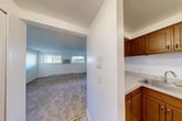 Located at 417 N Levitt St in Rome, NY, this one-bedroom, one-bathroom unit offers a practical and well-organized single-floor layout. The living room is the largest space in the unit, featuring wall-to-wall carpeting, bright white walls, and multiple windows that allow natural light to fill the room. A wall-mounted air conditioning unit and baseboard heating provide year-round climate control.

The kitchen is efficiently designed with rich, dark wood cabinetry, white countertops, and a sink. A pass-through counter opening connects the kitchen to the living area, creating an open, communal feel. Adjacent to the kitchen is a dedicated pantry, offering additional storage. Light wood-style flooring runs through the kitchen and entry areas.

The bedroom is a cozy, carpeted retreat with white walls, a six-panel door, and access to two closets, providing ample storage.

The bathroom is clean and functional, finished in an all-white palette with tile flooring, a vanity with under-sink storage, a mirrored medicine cabinet with overhead lighting, and a full tub-shower combination. The overall ambiance of the unit is bright, clean, and straightforward, making efficient use of its compact footprint.
