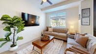 Located at 2100 North 10th Street in El Centro, California, this two-story home offers three bedrooms, three bathrooms, and a thoughtfully designed layout spread across two floors. The main level serves as the social hub of the home, featuring an open-concept living room and kitchen area alongside an attached garage. The living room is bright and welcoming, with light wood-style flooring, a ceiling fan, and a large window that fills the space with natural light and outdoor views. The kitchen is well-equipped with warm honey-toned cabinetry, granite-style countertops, black appliances including a gas range and French door refrigerator, and light wood flooring that flows seamlessly into the adjacent dining area. The attached garage provides direct access and ample storage space with a garage door opener. Upstairs, the three bedrooms are carpeted and generously sized, including a primary bedroom with windows offering outdoor views. The upper level also includes two closets and a hallway connecting the rooms. The bathrooms are finished with warm wood cabinetry, granite countertops, and light flooring — one featuring a dual-sink vanity with abundant natural light. Clean neutral tones and consistent finishes give the entire home a cohesive, move-in-ready feel.