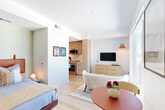 Located at 420 Mendocino Ave in Santa Rosa, CA, this thoughtfully designed one-bedroom, one-bathroom unit makes excellent use of its compact footprint across a single floor. Light wood flooring flows throughout, complementing the clean, modern aesthetic defined by white walls and contemporary fixtures.

The galley-style kitchen is well-appointed with light wood flat-front cabinetry, white quartz countertops, a white tile backsplash, and stainless steel appliances including a range, microwave, and refrigerator. The layout maximizes counter and storage space efficiently.

The open living area seamlessly connects to the dining space, with a large floor-to-ceiling window that floods the room with natural light and provides views of the surrounding Santa Rosa skyline. The bedroom area is integrated into this open plan, offering a cozy yet functional sleeping space.

The bathroom features large-format tile flooring, a tub-shower combination with white subway tile surround, and a warm wood vanity with a white countertop. A dedicated walk-in closet with built-in shelving and hanging rods provides organized storage. In-unit laundry adds further convenience. The overall ambiance is bright, modern, and efficiently designed for comfortable urban living.
