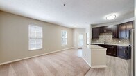Located in Columbus, OH, this well-appointed 1-bedroom, 1-bathroom residence offers a thoughtfully designed single-floor layout. The open-concept living, dining, and kitchen area serves as the heart of the home, where light wood-look flooring transitions seamlessly from the kitchen into the carpeted living space. Multiple windows dressed with blinds allow generous natural light throughout.

The kitchen is a standout feature, boasting rich dark-espresso cabinetry, a mosaic tile backsplash, light granite countertops, a central island for added prep space, and a full suite of stainless steel appliances including a refrigerator, range, microwave, and dishwasher.

The spacious primary bedroom offers plush carpeting, ample natural light from large windows, and access to a closet. The bathroom is finished with a dark-vanity cabinet, framed mirror, brushed nickel lighting fixtures, and a full soaking tub and shower combo set against clean white surrounds and wood-look flooring.

Additional conveniences include a dedicated laundry area, utility room, two closets for storage, a hallway, and a private balcony. Neutral warm-toned walls throughout the space create a calm, cohesive atmosphere well-suited for comfortable everyday living.