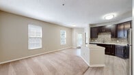 Located in Columbus, OH, this well-appointed 1-bedroom, 1-bathroom residence offers a thoughtfully designed single-floor layout. The open-concept living, dining, and kitchen area serves as the heart of the home, where light wood-look flooring transitions seamlessly from the kitchen into the carpeted living space. Multiple windows dressed with blinds allow generous natural light throughout.

The kitchen is a standout feature, boasting rich dark-espresso cabinetry, a mosaic tile backsplash, light granite countertops, a central island for added prep space, and a full suite of stainless steel appliances including a refrigerator, range, microwave, and dishwasher.

The spacious primary bedroom offers plush carpeting, ample natural light from large windows, and access to a closet. The bathroom is finished with a dark-vanity cabinet, framed mirror, brushed nickel lighting fixtures, and a full soaking tub and shower combo set against clean white surrounds and wood-look flooring.

Additional conveniences include a dedicated laundry area, utility room, two closets for storage, a hallway, and a private balcony. Neutral warm-toned walls throughout the space create a calm, cohesive atmosphere well-suited for comfortable everyday living.