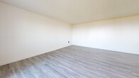 This 1080 square foot condominium in Rancho Palos Verdes offers a harmonious blend of comfort and style. The open floor plan showcases a bright, airy living space with a seamless flow between rooms. The kitchen is a highlight, featuring sleek white cabinetry, stainless steel appliances, and grey quartz countertops, creating a modern and functional cooking area.

The two bedrooms are generously sized, with the primary bedroom boasting 190 square feet of space. Plush carpeting in the bedrooms provides a cozy feel, while the living areas feature durable, attractive wood-look flooring. Both bathrooms are well-appointed with clean lines and contemporary fixtures.

Large windows throughout the unit allow for ample natural light and offer picturesque views, particularly from the kitchen where a sliding glass door likely leads to an outdoor space. The textured ceilings add character to the rooms, and the neutral color palette provides a versatile backdrop for various decor styles.

Storage is thoughtfully integrated, with closets in the bedrooms and additional cabinetry in the kitchen. The unit's layout, as seen in the 3D floor plan, ensures efficient use of space while maintaining a sense of openness. This condo presents an ideal opportunity for those seeking a turnkey property in a desirable coastal location.