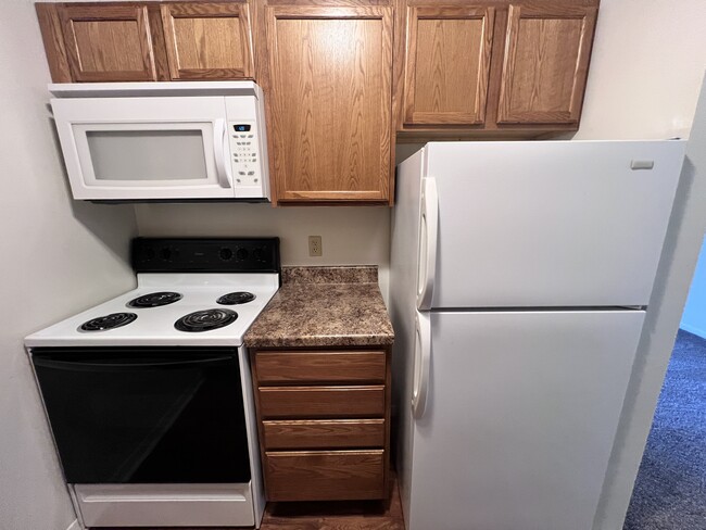 Kitchen W/ Microwave - Gold Falls Villa Apartments