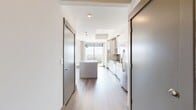 This contemporary 690 square foot apartment maximizes space with its efficient one-bedroom, one-bathroom layout. The heart of the home is a bright, open-concept living area featuring expansive windows that flood the space with natural light and provide stunning city views. Sleek hardwood floors run throughout, creating a seamless flow and enhancing the modern aesthetic.

A standout architectural element is the exposed concrete column, which adds an industrial touch to the otherwise polished interior. The kitchen, while not visible in the image, is likely integrated into this open space, promoting a social atmosphere. The bedroom, measuring 150 square feet, offers a cozy retreat.

The apartment's design emphasizes functionality without sacrificing style. A closet provides essential storage, while the single bathroom likely features modern fixtures to complement the overall design. The urban setting visible through the windows suggests a prime location, offering residents easy access to city amenities.

This apartment is ideal for those seeking a contemporary living space with abundant natural light and city views in a compact, well-designed package.