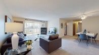 Located at 100 Hunters Crossing Dr in Elyria, Ohio, this thoughtfully designed 2-bedroom, 2-bathroom single-floor home offers a comfortable and functional layout. The spacious living room is a standout feature, anchored by a fireplace and large sliding glass doors that flood the space with natural light while providing outdoor views. Plush carpeting and a textured ceiling add warmth to the open feel. The living area flows seamlessly into a dedicated dining space, complete with a ceiling fan overhead. The kitchen is well-equipped with warm oak cabinetry, granite-style countertops, stainless steel appliances including a refrigerator, dishwasher, and range, and light wood-style flooring. A dedicated office with a large window offering exterior views adds valuable versatility to the floor plan. The generously sized primary bedroom features carpeted floors, a windowed wall with views outside, and ample space for furnishings. Both bathrooms are clean and modern, with one featuring wood-style flooring and a bright vanity. A dedicated laundry room with full-size side-by-side washer and dryer rounds out this well-appointed home.