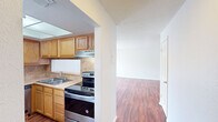 This well-designed 860 square foot apartment offers a practical and comfortable living space. The unit features two bedrooms, including a primary bedroom of 150 square feet, providing ample space for rest and relaxation. The single bathroom is equipped with a modern vanity and mirror, catering to the occupants' daily needs.

The apartment's layout maximizes space efficiency with an open-concept design that combines the kitchen and living room. The kitchen boasts honey-toned wooden cabinetry, complemented by stainless steel appliances including a refrigerator and dishwasher. A convenient breakfast bar separates the kitchen from the living area, ideal for casual dining or additional workspace.

Throughout the apartment, rich hardwood floors add warmth and elegance to the space. The living room features a sliding glass door, allowing natural light to flood the area and providing access to an outdoor space. A ceiling fan in the living room ensures comfort and air circulation.

Storage is abundant with multiple closets, including walk-in options in the bedrooms. The closets are outfitted with wire shelving systems for organized storage. The apartment's neutral color palette, predominantly in shades of white, creates a bright and airy ambiance, allowing for personalized decor.

Additional amenities include central heating and air conditioning, ensuring year-round comfort. The thoughtful design and efficient use of space make this apartment an ideal choice for those seeking a comfortable and functional living environment.